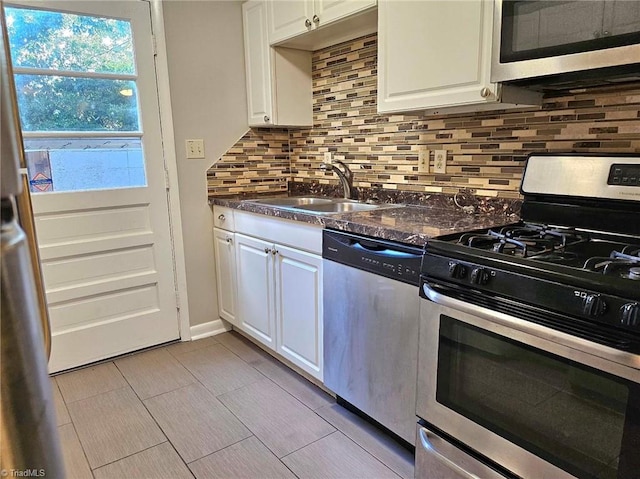 kitchen featuring tasteful backsplash, sink, stainless steel appliances, and white cabinets