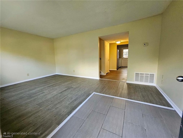 unfurnished room featuring dark wood-type flooring