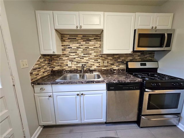 kitchen featuring white cabinets, appliances with stainless steel finishes, backsplash, and sink