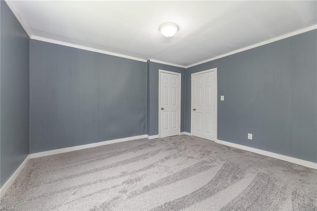 empty room with carpet and ornamental molding