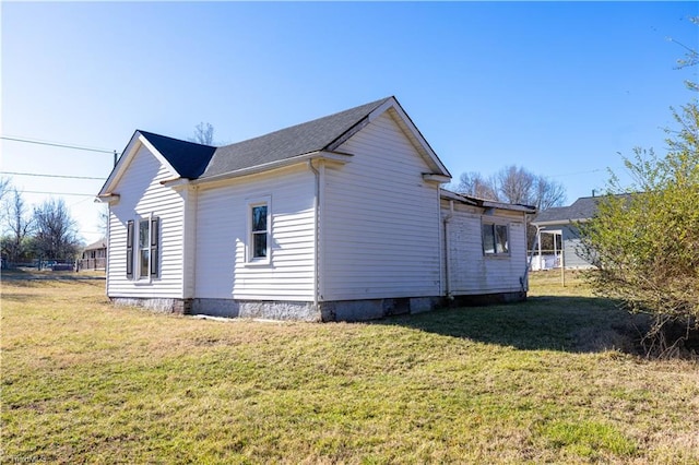 view of side of home with a yard