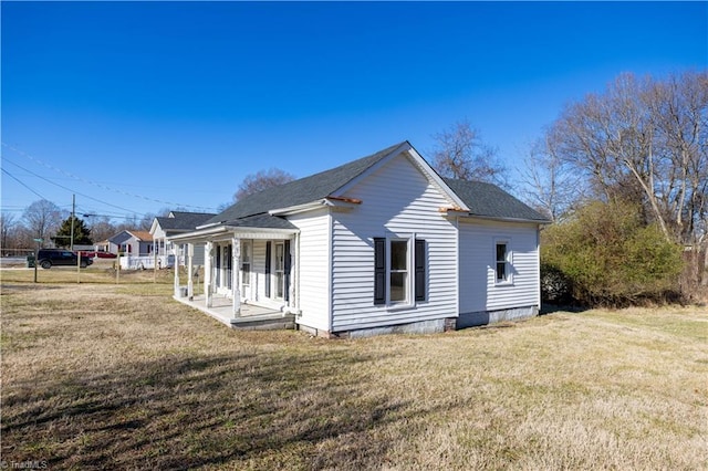 view of side of property with a lawn