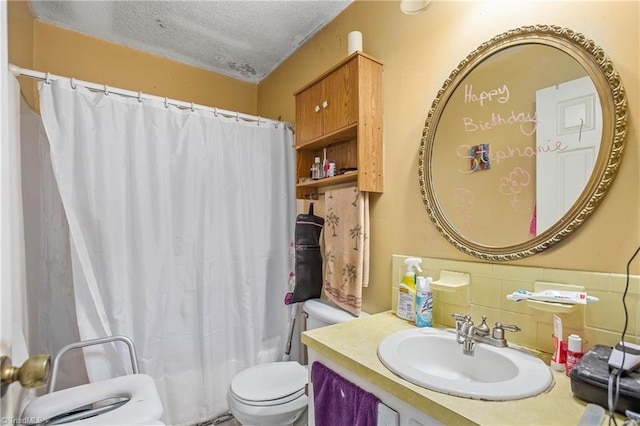 bathroom with a sink, a textured ceiling, and toilet