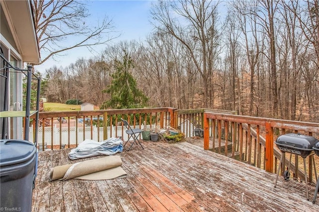 wooden terrace with a grill