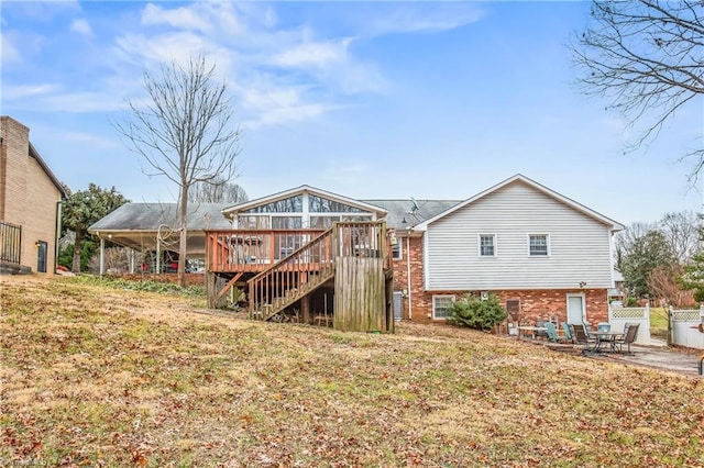 back of property featuring a patio, brick siding, a yard, stairway, and a wooden deck