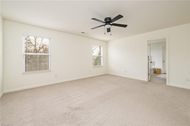 carpeted spare room with ceiling fan