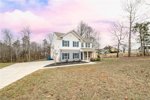 view of front property with a porch and a yard