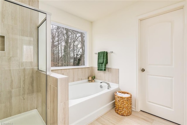 bathroom featuring independent shower and bath