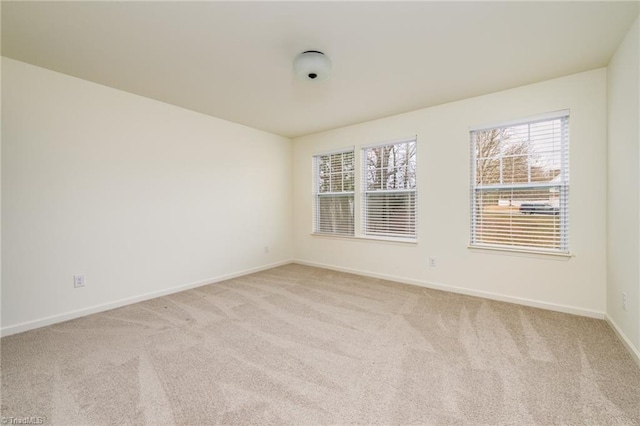 unfurnished room with light carpet