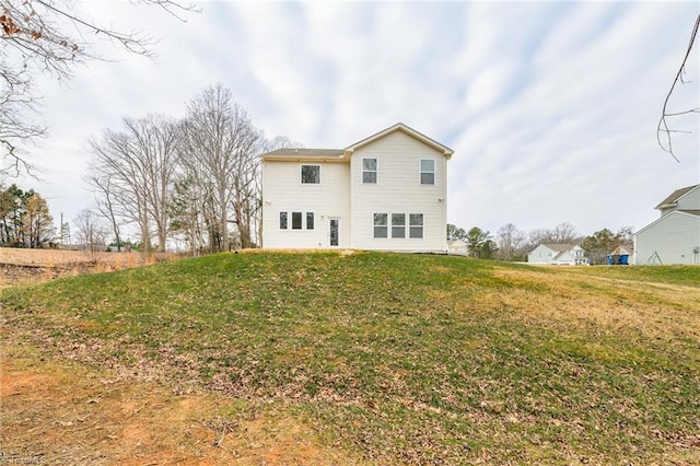 rear view of property with a yard