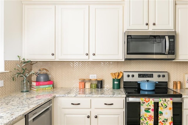 kitchen featuring stainless steel appliances and white cabinets