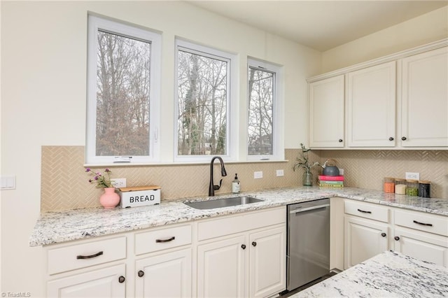 kitchen featuring white cabinetry, dishwasher, sink, and tasteful backsplash