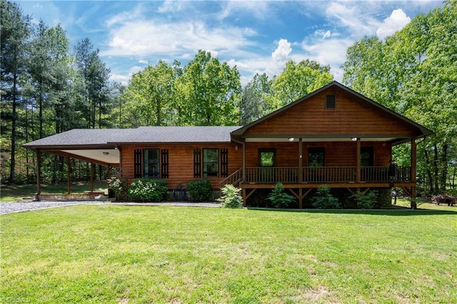 log-style house with a porch, a front lawn, driveway, and a carport