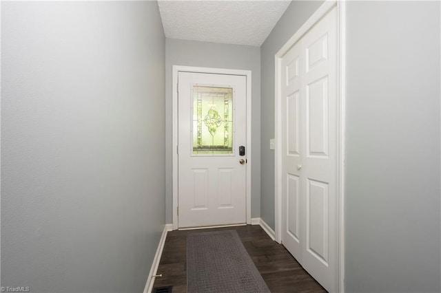 entryway with baseboards, dark wood-style floors, and a textured ceiling