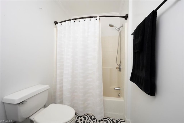 bathroom featuring toilet and shower / bath combination with curtain