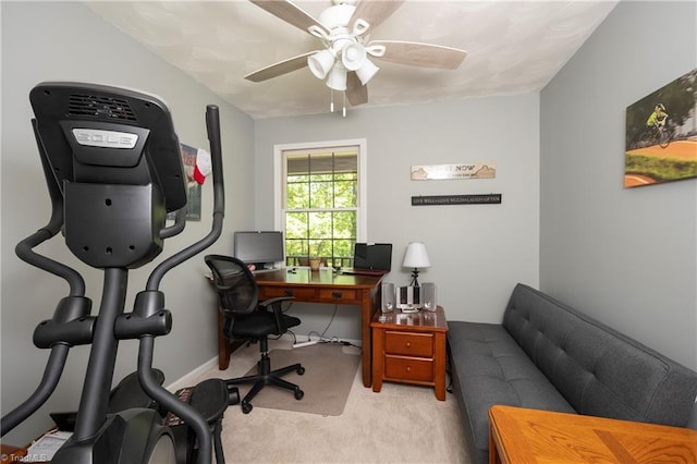 carpeted office space featuring a ceiling fan