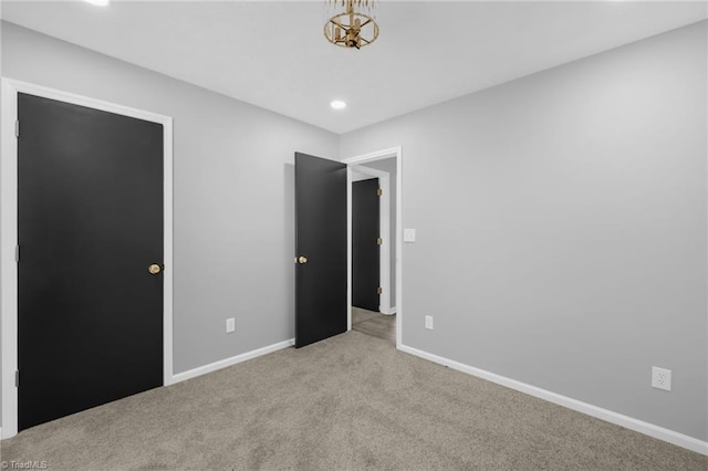 unfurnished bedroom featuring light colored carpet