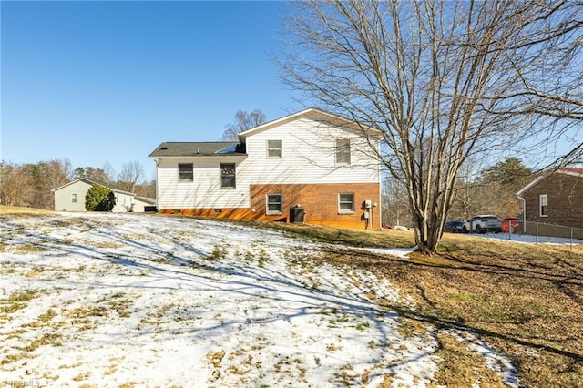 view of snow covered back of property