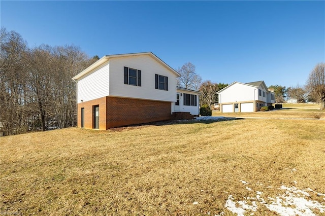 view of side of property featuring a lawn and a garage