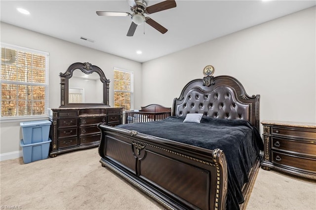 bedroom with ceiling fan and light colored carpet