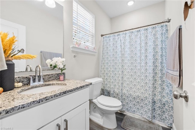 bathroom featuring hardwood / wood-style flooring, vanity, and toilet