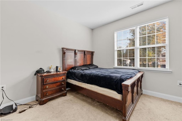 bedroom featuring light colored carpet