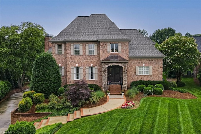 925 Salem Glen Ct, Clemmons, NC 27012 - view of front of home featuring a front lawn, a chimney, brick siding, and roof with shingles