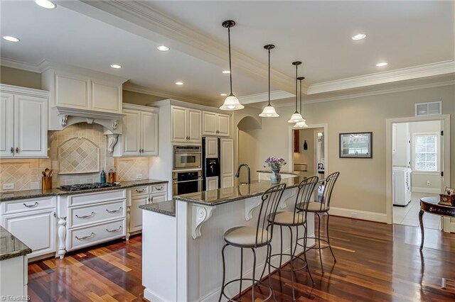 925 Salem Glen Ct, Clemmons, NC 27012 - kitchen with black gas cooktop, paneled built in refrigerator, dark wood-style floors, tasteful backsplash, and crown molding