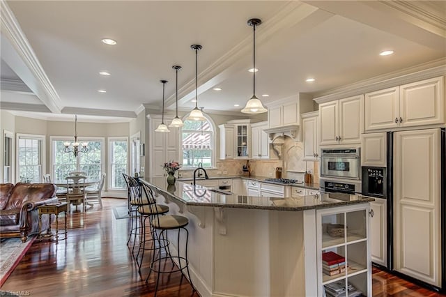 925 Salem Glen Ct, Clemmons, NC 27012 - kitchen with paneled fridge, a breakfast bar area, tasteful backsplash, ornamental molding, and white cabinetry