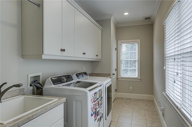 925 Salem Glen Ct, Clemmons, NC 27012 - laundry area featuring independent washer and dryer, cabinet space, crown molding, light tile patterned floors, and recessed lighting