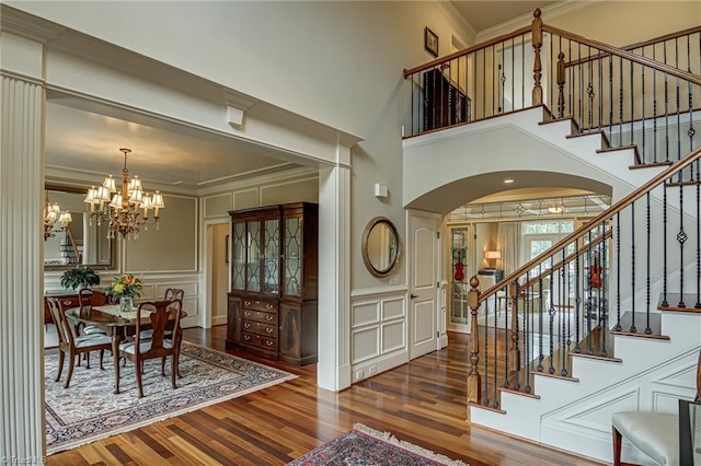 925 Salem Glen Ct, Clemmons, NC 27012 - entryway with a decorative wall, arched walkways, wood finished floors, stairway, and a chandelier