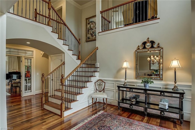 925 Salem Glen Ct, Clemmons, NC 27012 - stairs featuring arched walkways, wood finished floors, wainscoting, crown molding, and a high ceiling