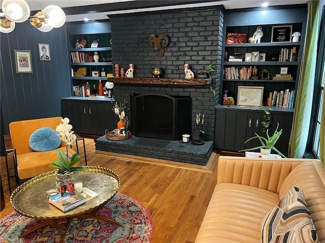 590 Knob View Dr, Winston-Salem, NC 27104 - living room featuring a brick fireplace, wood finished floors, ornamental molding, and built in shelves