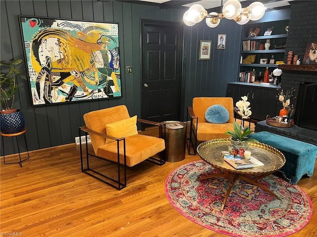 590 Knob View Dr, Winston-Salem, NC 27104 - living area with wood finished floors, a chandelier, and a fireplace