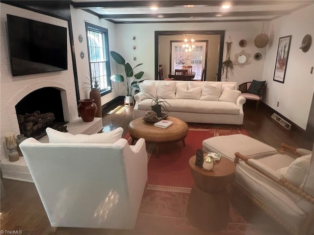 590 Knob View Dr, Winston-Salem, NC 27104 - living area with wood finished floors, a chandelier, and a brick fireplace
