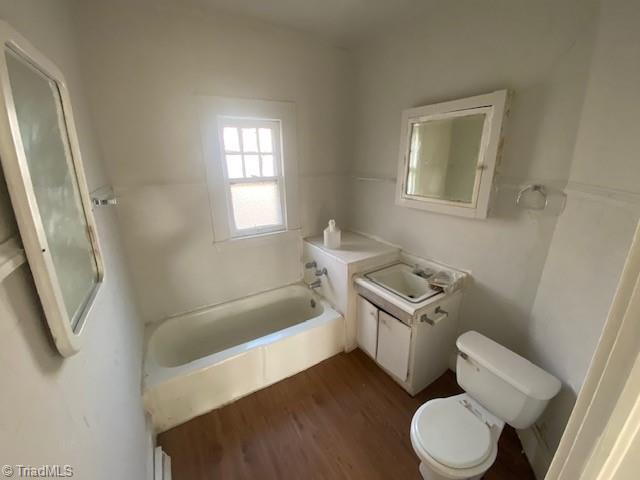 bathroom featuring vanity, toilet, and hardwood / wood-style floors