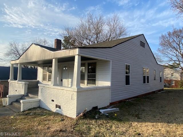 view of side of property with a porch