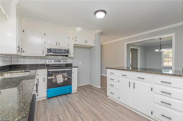 kitchen featuring light hardwood / wood-style floors, white cabinetry, appliances with stainless steel finishes, and dark stone counters