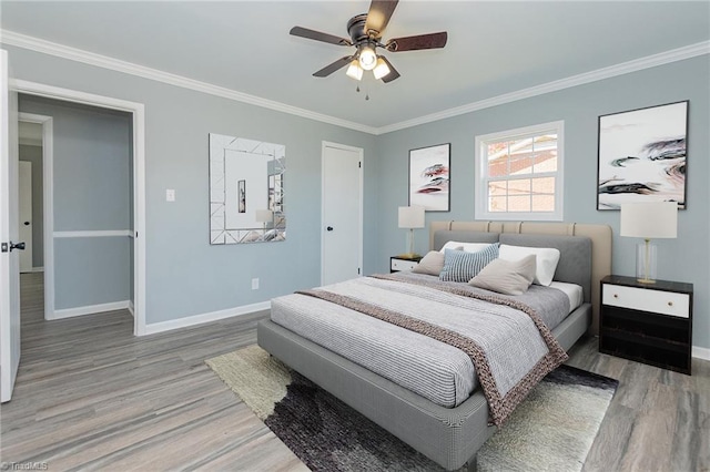 bedroom with hardwood / wood-style flooring, ceiling fan, and ornamental molding