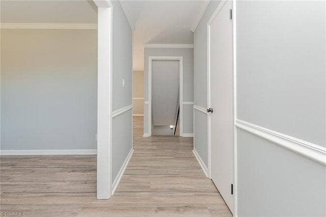 corridor with crown molding and light hardwood / wood-style floors