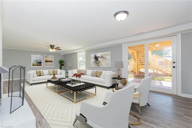 living room featuring ceiling fan and wood-type flooring