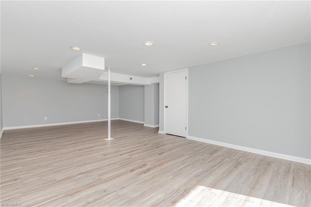 basement with light hardwood / wood-style floors