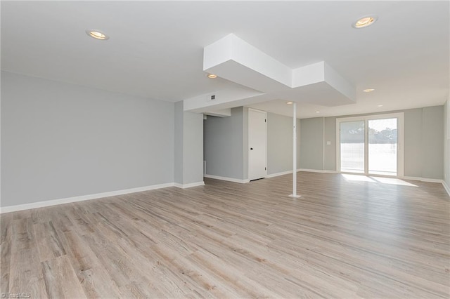 empty room with light hardwood / wood-style flooring