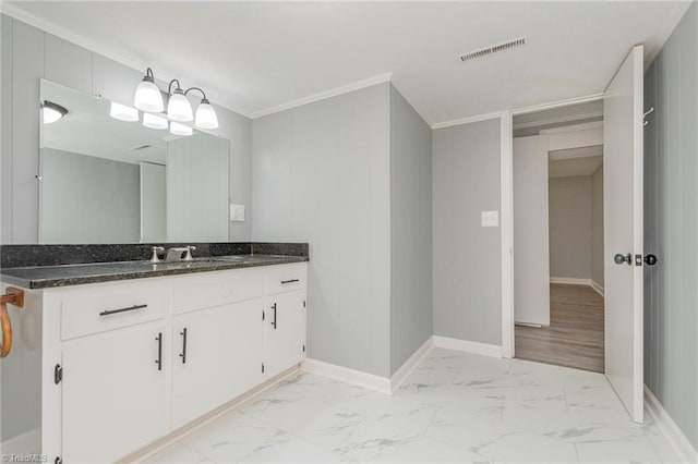 bathroom featuring vanity, crown molding, and wood walls