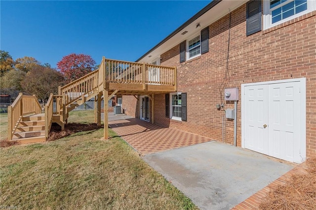 rear view of house with a lawn, cooling unit, and a deck