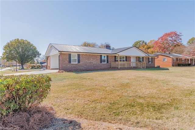 ranch-style home with covered porch, a garage, and a front lawn