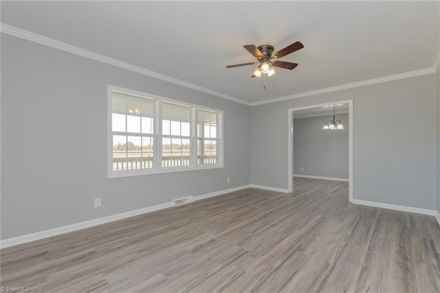 unfurnished room featuring ceiling fan with notable chandelier, light hardwood / wood-style flooring, and ornamental molding