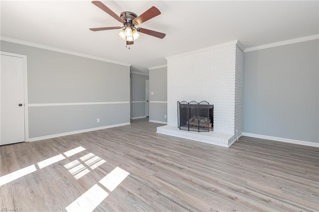 unfurnished living room with a fireplace, ceiling fan, light hardwood / wood-style flooring, and ornamental molding