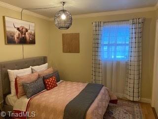 2920 Ramsgate Ct, Winston-Salem, NC 27106 - bedroom featuring ornamental molding and wood finished floors