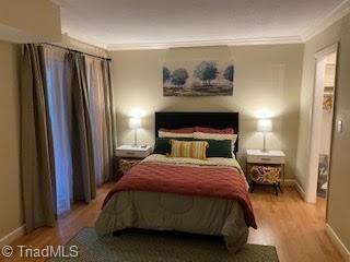 2920 Ramsgate Ct, Winston-Salem, NC 27106 - bedroom with wood finished floors and ornamental molding